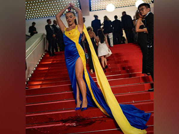 Woman draped in 'Ukrainian colours' pours fake blood on herself at Cannes red carpet