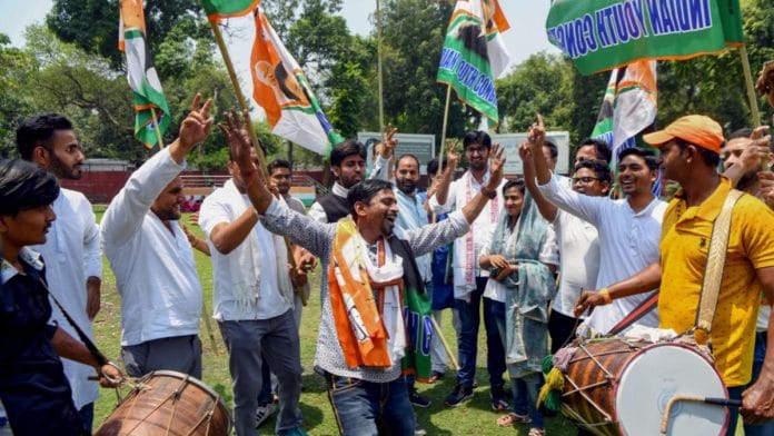 Congress supporters celebrate the party's performance in Karnataka assembly elections at the party office in New Delhi, Saturday | ANI