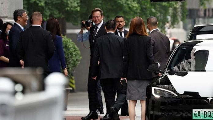 Tesla Chief Executive Officer Elon Musk stands near Chinese Commerce Minister Wang Wentao before leaving the Chinese Ministry of Commerce in Beijing on 31 May, 2023 | Reuters