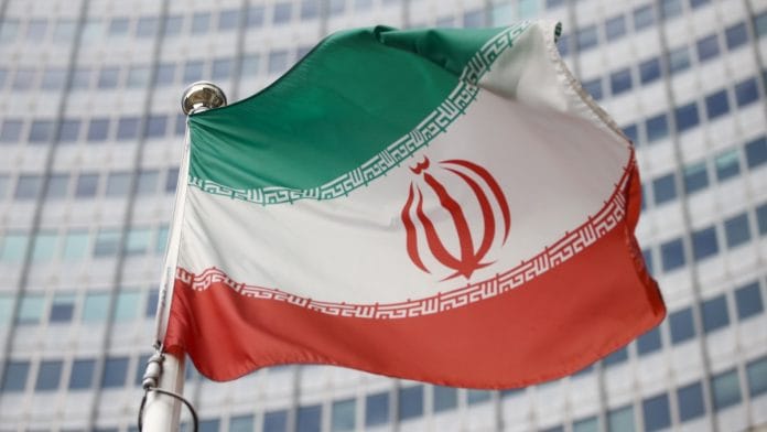 The Iranian flag waves in front of the International Atomic Energy Agency (IAEA) headquarters | Reuters file photo/Lisi Niesner