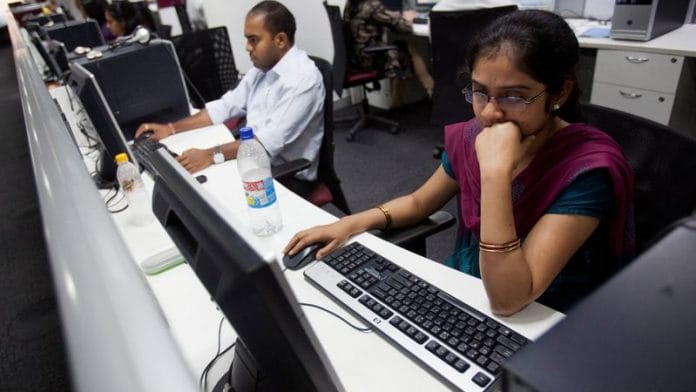 Workers are seen at their workstations on the floor of an outsourcing centre in Bangalore | File Photo: Reuters