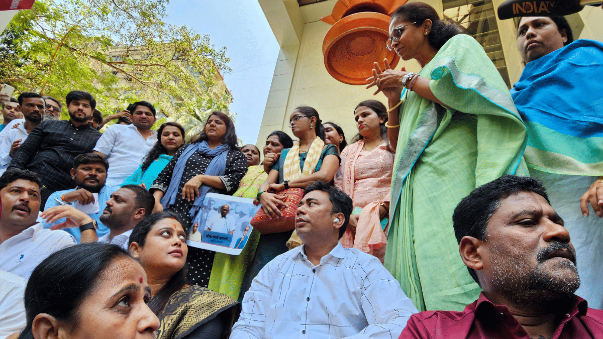 Nationalist Congress Party MP Supriya Sule speaks with party workers sitting on a protest in Mumbai on Thursday | ANI