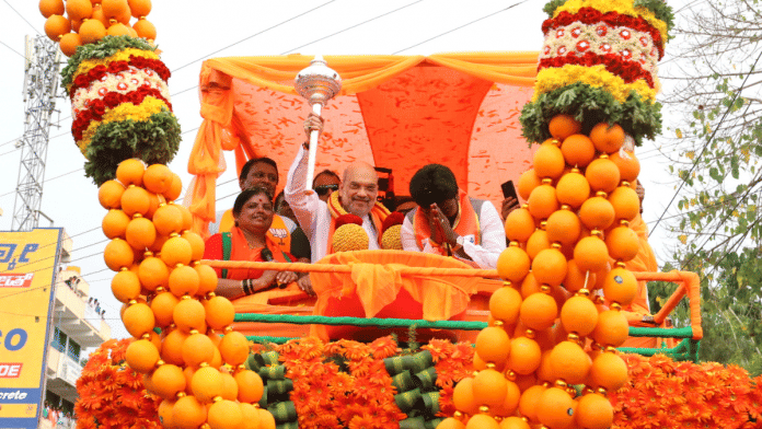 Union Home Minister Amit Shah during a BJP road show in poll-bound Karnataka I Twitter | @AmitShah
