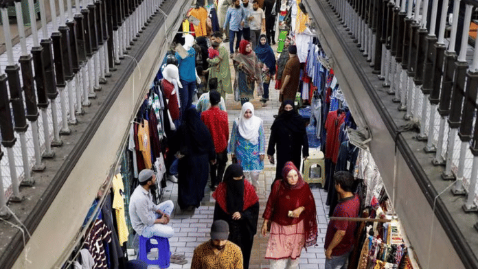 People walk as they shop in a market, ahead of Eid al-Fitr celebrations in Karachi, Pakistan | Reuters file photo/Akhtar Soomro