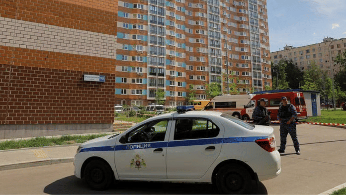 Russian law enforcement officers stand guard near a damaged multi-storey apartment block following a reported drone attack in Moscow, on 30 May 2023 | Reuters/Evgenia Novozhenina