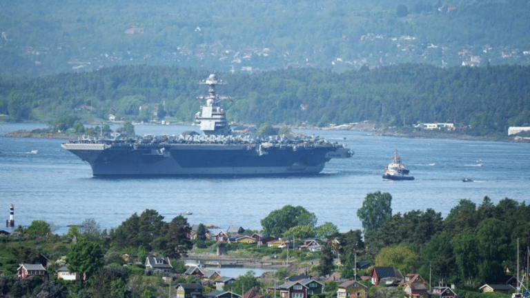 World’s largest aircraft carrier sails into Oslo amid tension between NATO, Russia