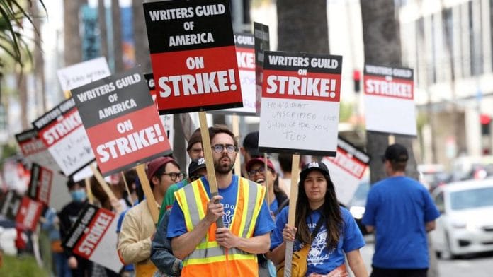 Writers Guild of America members and supporters picket outside Sunset Bronson Studios and Netflix Studios, after union negotiators called a strike for film and television writers, in Los Angeles, California on 3 May, 2023 | Reuters