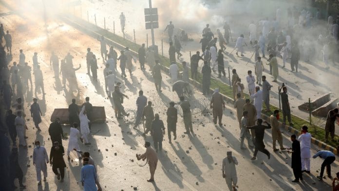 Supporters of Pakistan's former Prime Minister Imran Khan participate in a protest against his arrest, in Peshawar, Pakistan, on 9 May 2023 | Reuters