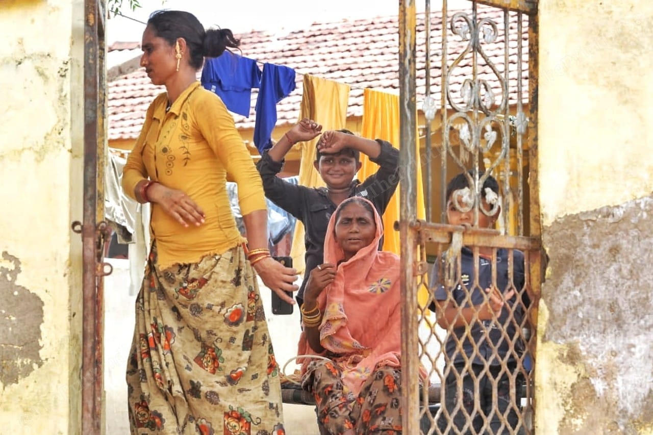 Sonal, a sex worker hurries to go inside. Beside her is her mother, Suriya, a former sex worker who quit the trade due to kidney ailment | Photo: Praveen Jain | ThePrint