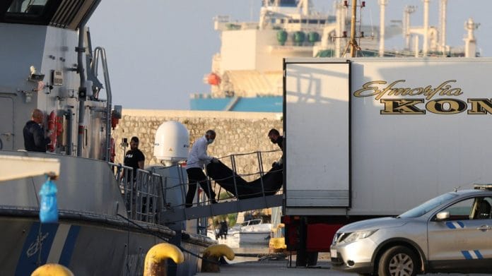 Men transfer body bags carrying migrants who died after their boat capsized in the open sea off Greece, onboard a Hellenic Coast Guard vessel at the port of Kalamata, Greece | Reuters