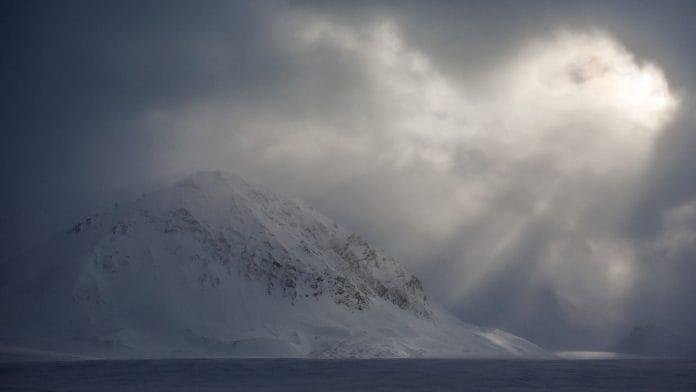 The sun shimmers through a cloud cover near Ny-Alesund, Svalbard, Norway | Reuters
