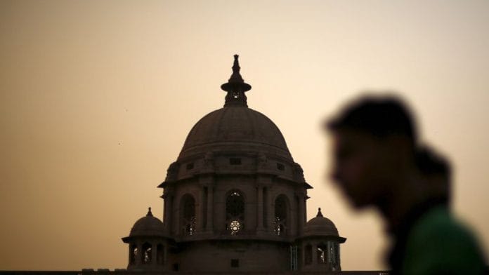 A commuter walks past the building of India's Ministry of Finance during dusk in New Delhi/File Photo: Reuters