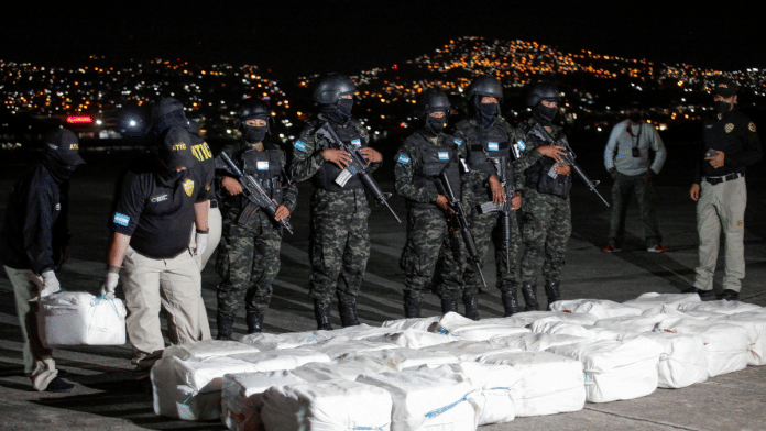 Officers of Honduras' Technical Agency for Criminal Investigation carry a package containing cocaine seized during a police operation in Tegucigalpa | Reuters file photo