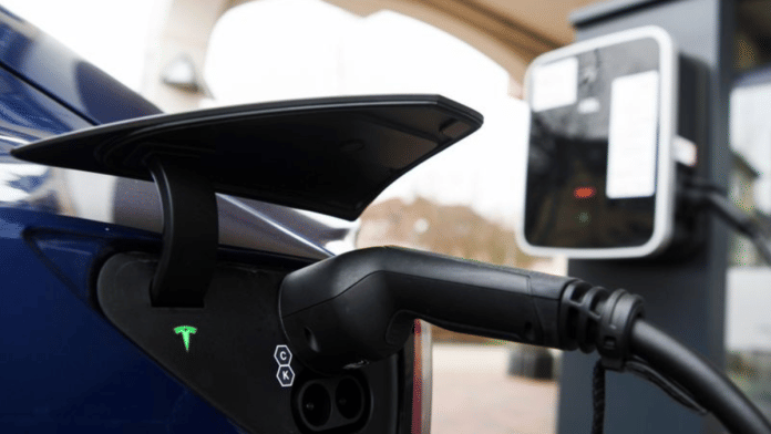 The charging plug of a Tesla electric car is pictured on a charging station at the market place in Gruenheide, near Berlin, Germany/File Photo: Reuters