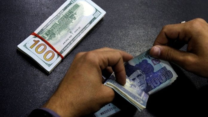 A currency trader counts Pakistani Rupee notes as he prepares an exchange of US dollars in Islamabad | Reuters file photo