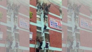 People escape using wires as a fire breaks out in a building located in Delhi's Mukherjee Nagar, on Thursday | ANI