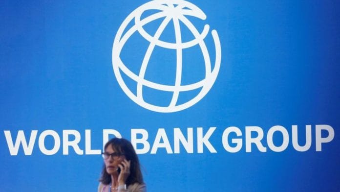 A participant stands near a logo of World Bank at the International Monetary Fund - World Bank Annual Meeting 2018 in Nusa Dua, Bali, Indonesia, October 12, 2018. REUTERS/Johannes P. Christo/File Photo