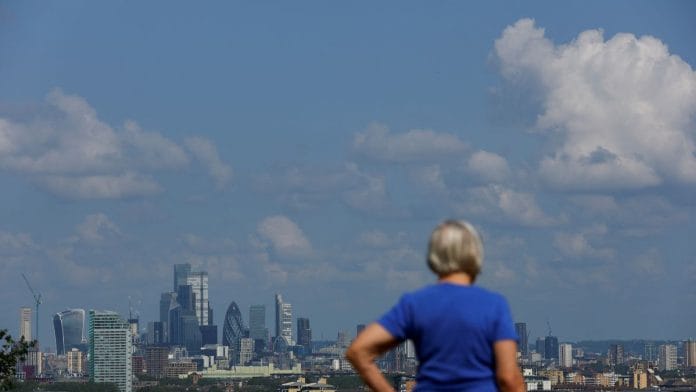 A person looks at the City of London financial district over from Greenwich Park, in London, Britain June 22, 2023/Reuters