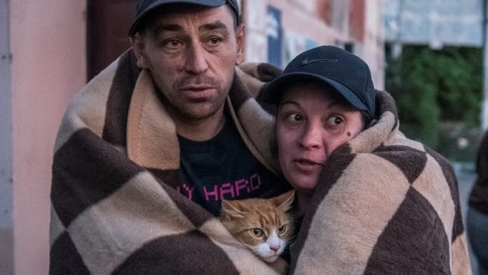 Local residents react after their evacuation from a flooded area after the Nova Kakhovka Dam breached in Kherson, Ukraine, on 6 June 2023 | Reuters/Vladyslav Musiienko