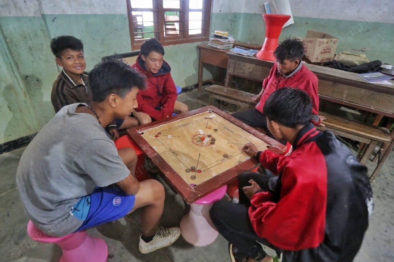Children play carom at the shelter Photo: Praveen Jain | ThePrint