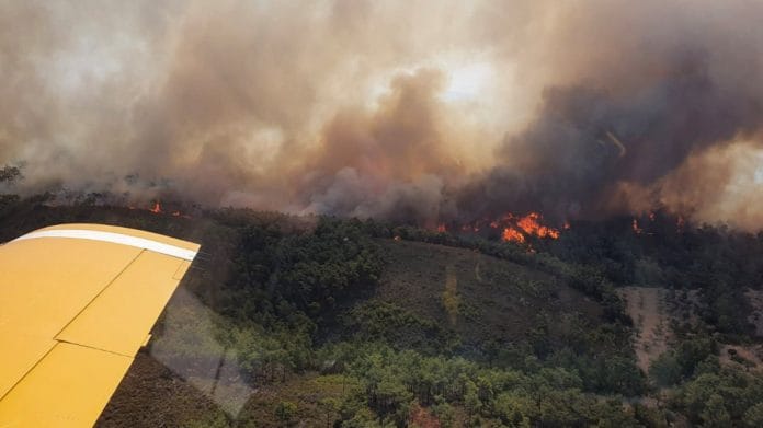 A Turkish firefighting plane flies over a wildfire burning on the island of Rhodes, Greece | Reuters