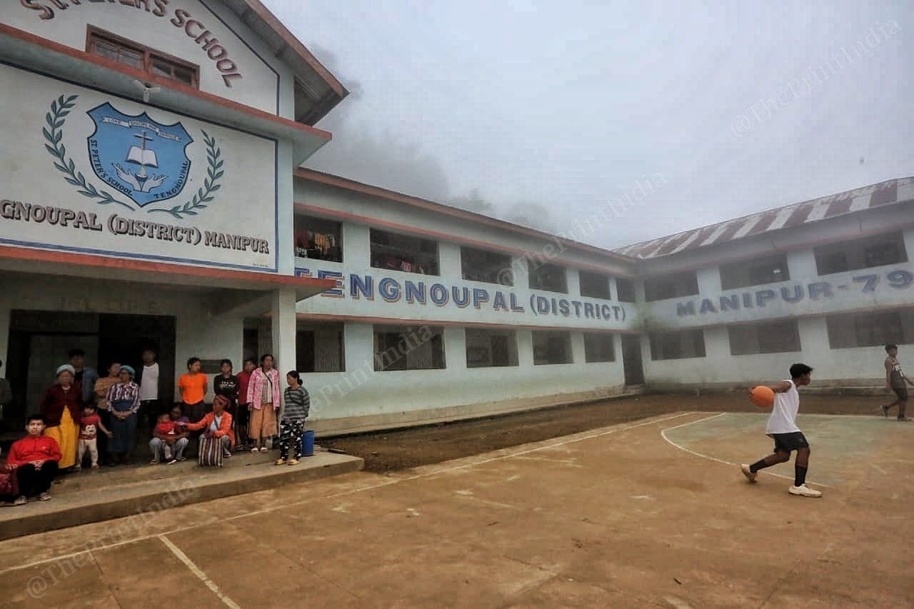 Women sit at the gate of the hostel in evening. This is how they keep themselves busy in the shelter Photo: Praveen Jain | ThePrint