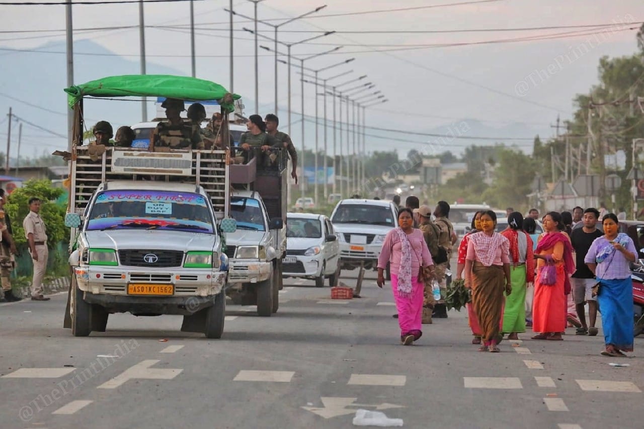 Meira Paibis walk on the highway beside a convoy of security forces' vehicles | Photo: Praveen Jain | ThePrint