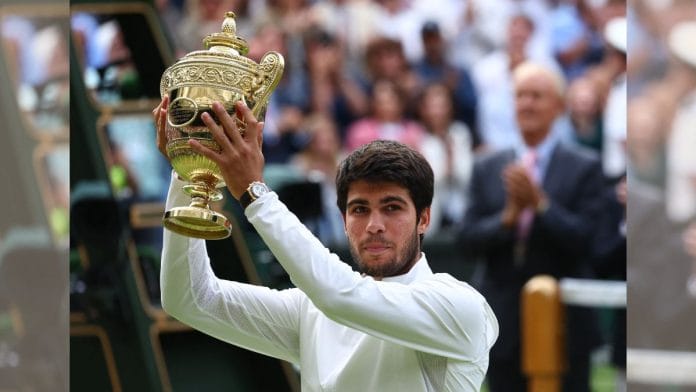 Carlos Alcaraz celebrates with the trophy after winning his final match against Serbia's Novak Djokovic | Reuters /Toby Melville