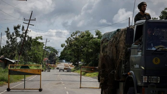 A security force trooper rides a vehicle on a highway, at Torbung village in Churachandpur district, Manipur | Reuters