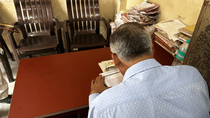 Singh in his transport business office | Jyoti Yadav/ThePrint