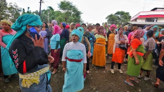 A Meitei woman talks on the phone while the group guards a highway in Manipur | Praveen Jain | ThePrint