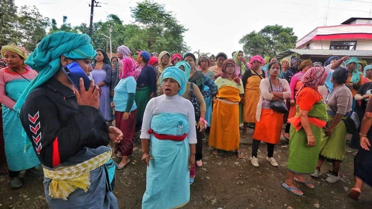 A Meitei woman talks on the phone while the group guards a highway in Manipur | Praveen Jain | ThePrint