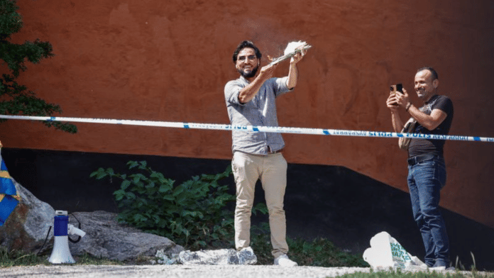 A demonstrator burns the Koran outside Stockholm's central mosque in Stockholm, Sweden, on 28 June 2023 | TT News Agency/Stefan Jerrevang/via Reuters