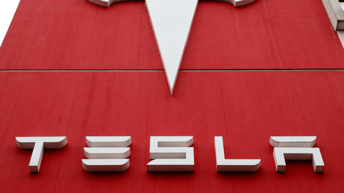 The logo of car manufacturer Tesla is seen at a branch office in Bern, Switzerland | Reuters