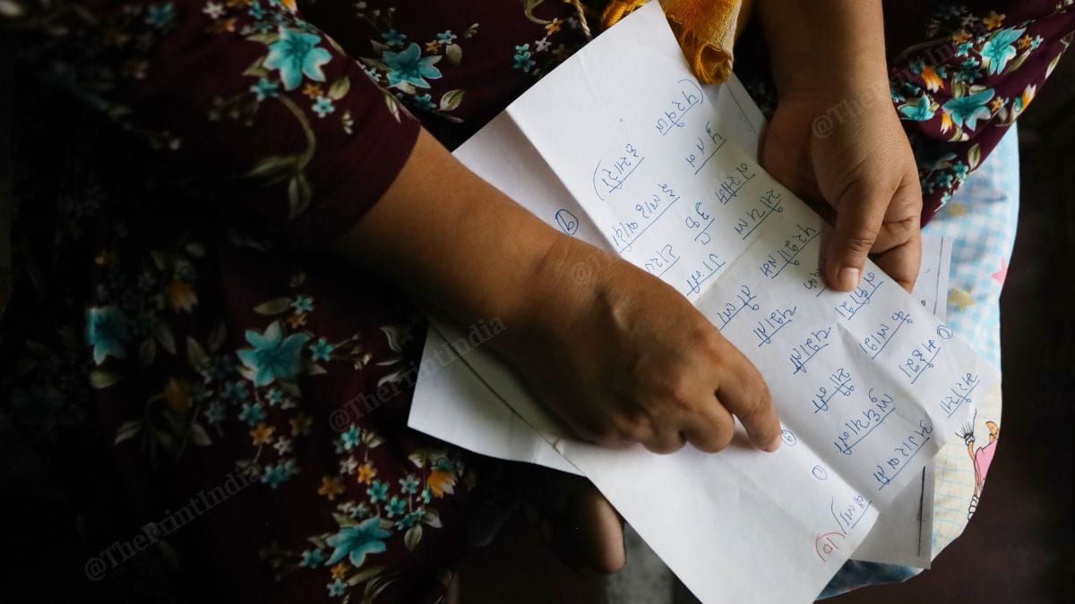 One of the survivors, who has written the names of all the accused, reads them | Manisha Mondal, ThePrint