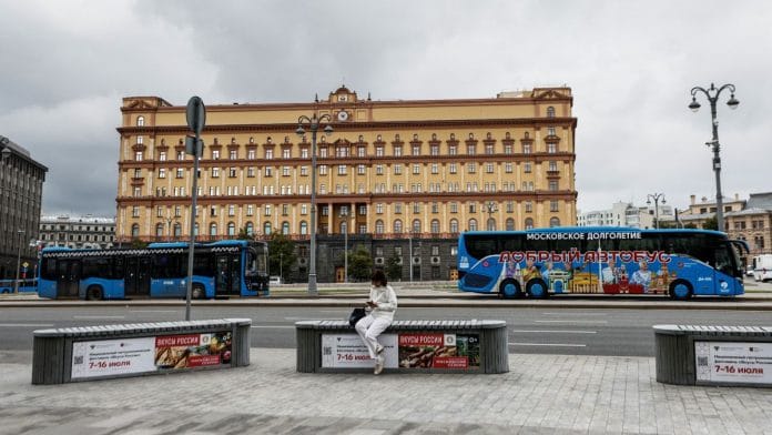A woman uses her mobile phone in front of the Federal Security Service (FSB) building on Lubyanka Square in Moscow, Russia | Reuters