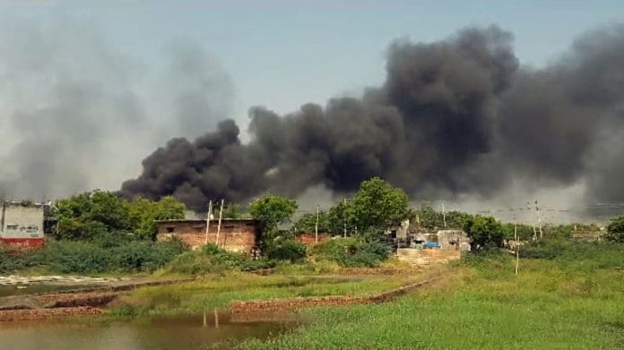 Huge smoke billows from an area after a clash erupted between two groups in Haryana's Nuh on Monday | ANI