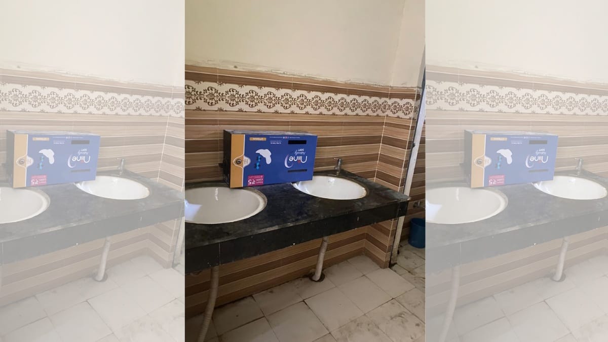 A sanitary napkin dispenser lying upside down in a women's washroom on campus | Shikha Salaria | ThePrint