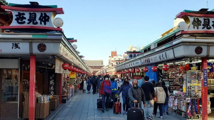 Tourists wearing protective face masks are seen at Asakusa district in Tokyo, Japan | Reuters file photo