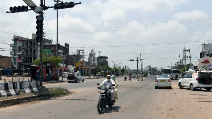 Commuters seen after violence ebbs in Haryana's Nuh, Thursday | ANI