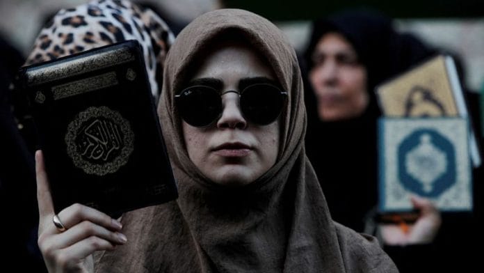 Protesters hold copies of the Koran as they demonstrate outside the Consulate General of Sweden in Istanbul, Turkey, July 30, 2023 | Reuters