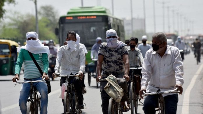 People cover their faces and heads to protect themselves from scorching heat as they ride bicycles during a hot summer day in New Delhi | ANI file photo