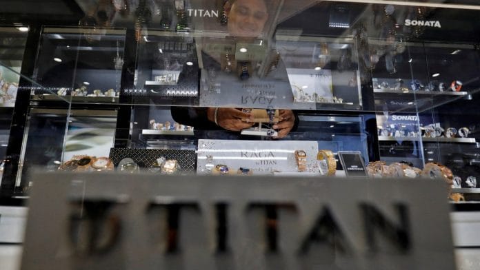 A salesperson arranges wristwatches inside a Titan World showroom in Ahmedabad | Reuters