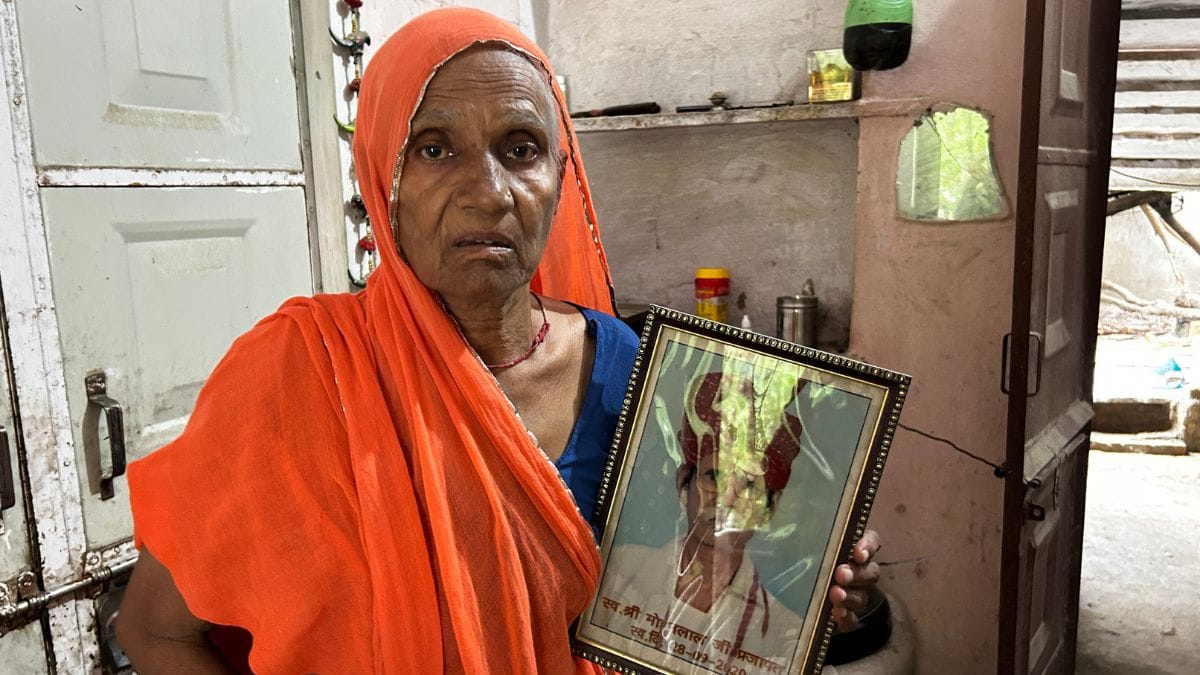 Bhanwari Devi holding a photo of her husband, Mohan Lal Prajapat. He died of cancer in 2020. | Photo: Jyoti Yadav | ThePrint