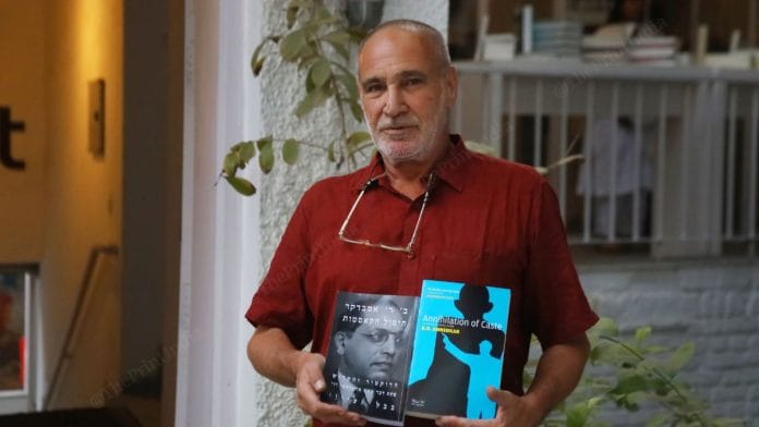 Sharon Rotbard, publisher of Babel, poses with the Hebrew edition of Annihilation of Caste | Photo: Manisha Mondal, ThePrint