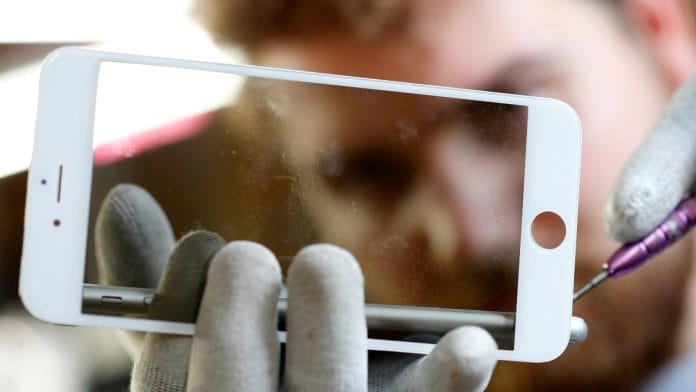 A worker refurbishes an Apple Iphone cell phone at a workshop in Lusignac, France | Representational image | Reuters