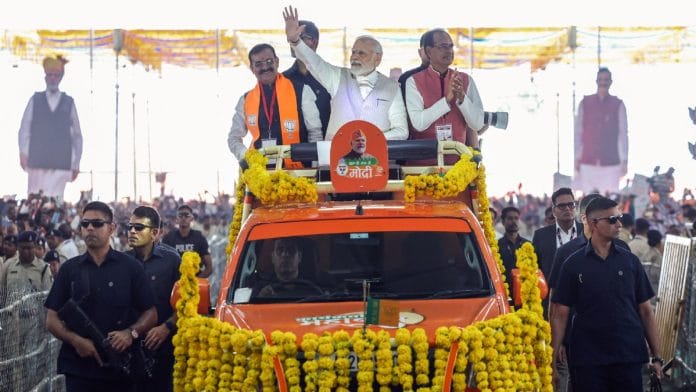 Prime Minister Narendra Modi waves to the supporters as he arrives to address the BJP 'Karyakarta Mahakumbh', in Bhopal on Monday. Madhya Pradesh CM Shivraj Singh Chouhan and party state chief VD Sharma are also seen | ANI