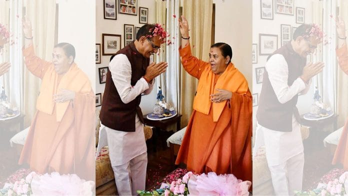 File photo of Uma Bharti showering CM Shivraj Singh Chouhan with flower petals | ANI