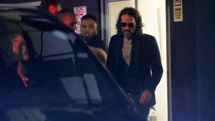 British comedian and actor Russell Brand walks outside the Wembley Park Theatre, in northwest London, Britain | Reuters