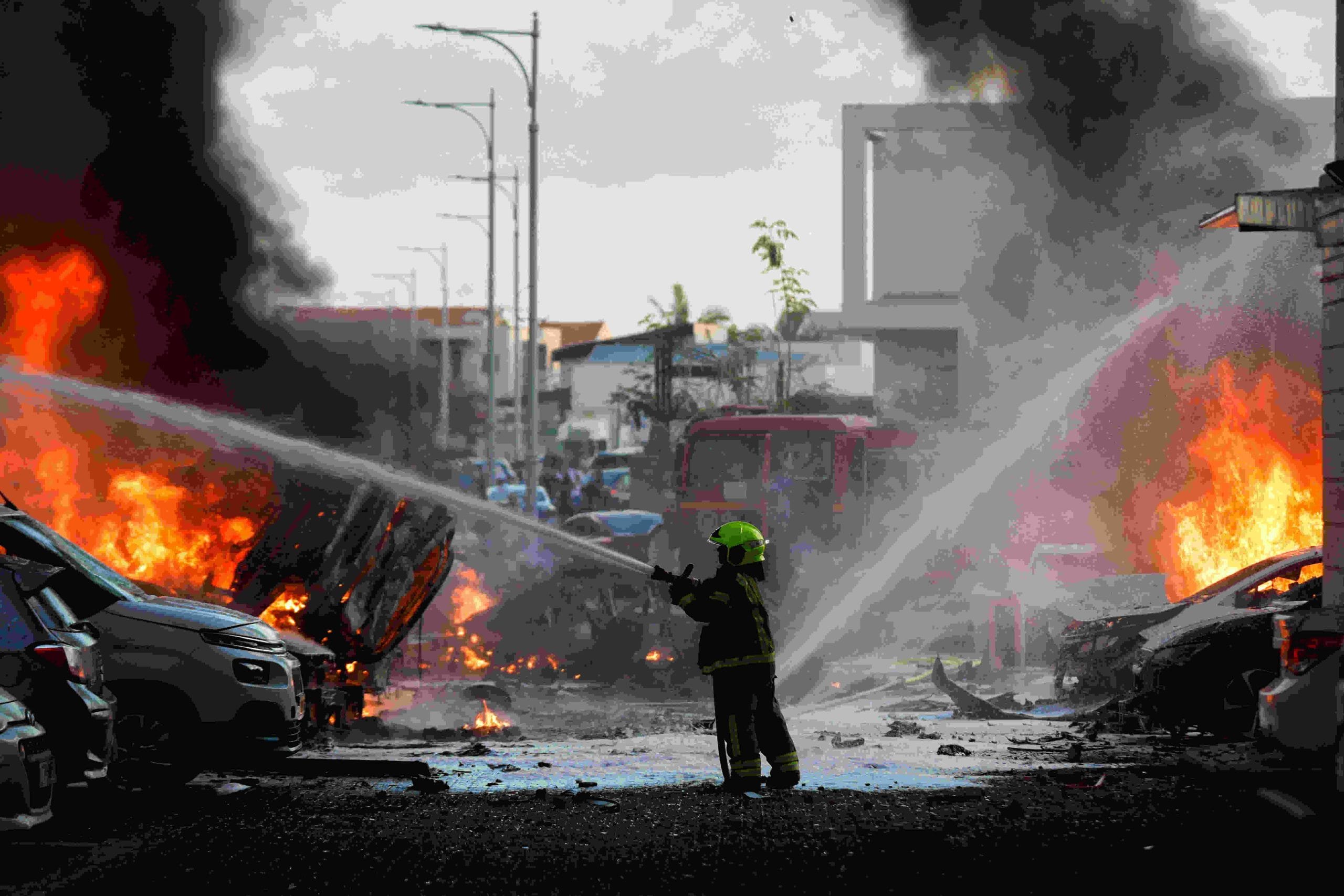 An emergency personnel works to extinguish fire after rockets are launched from Gaza Strip, as seen from the city of Ashkelon, Israel | Reuters 